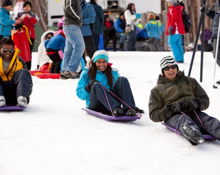 Guests enjoying tobogganing in The Lake Mountain Alpine Resort