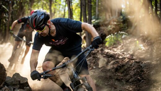 a man wearing gloves riding down the mountain